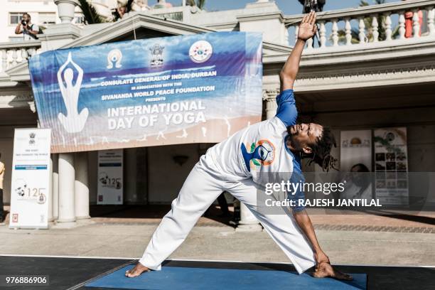 Yoga instructor takes part in a yoga session at North Beach on June 17, 2018 in Durban, South Africa, ahead of the International Day of Yoga on June...
