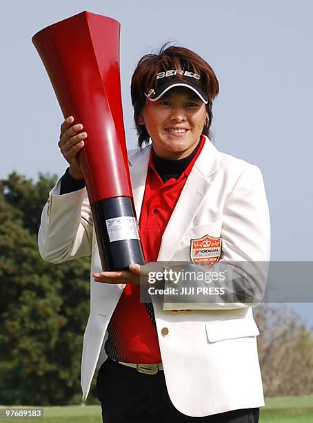 Taiwanese golfer Wei Yun-jye holds the trophy of the Yokohama Tire PRGR Ladies Cup golf tournament at the Tosa Country Club in Konan city in Kochi...