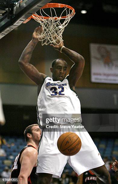 Doug Thomas of the Reno Bighorns dunks over Utah Flash defender Kosta Koufos during the NBA D-League game between Utah Flash and Reno Bighorns at the...