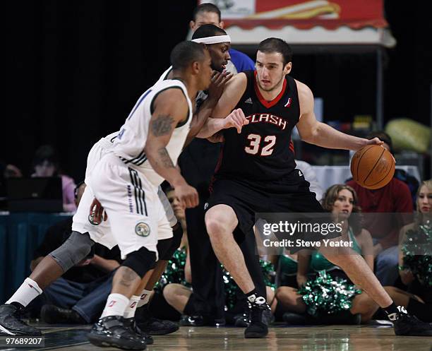 Kosta Koufos of the Utah Flash drives to the basket against Reno Bighorns defenders during the second half an NBA D-League game at the Reno Events...