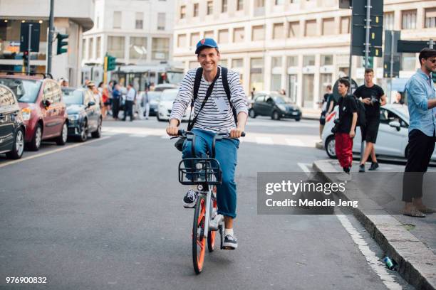 Photographer Kuba Dabrowski on a bike during Milan Men's Fashion Week Spring/Summer 2019 on June 16, 2018 in Milan, Italy.