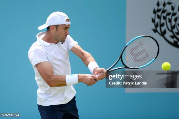 Tim Smyczek of the United States hits a backhand during the qualifying match against Thanasi Kokkinakis of Australia during qualifying Day 2 of the...