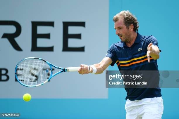 Julien Benneteau of France hits a forehand during the qualifying match against Mackenzie McDonald of the United States during qualifying Day 2 of the...