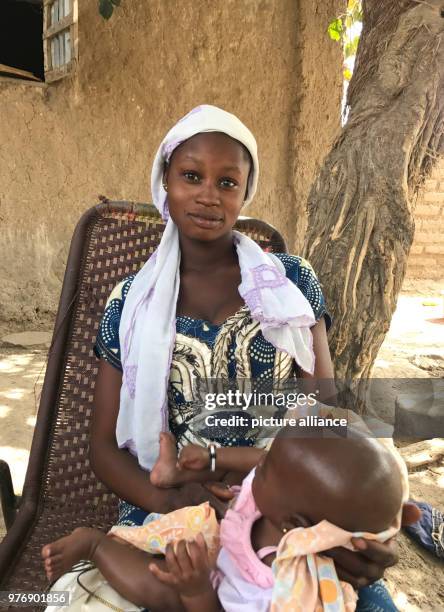 Year-old girl Minata from central Mali holds her two-and-a-half-month-old baby in M'Pentièrébougou, Mali, 20 March 2018. Minata said she was 12 years...