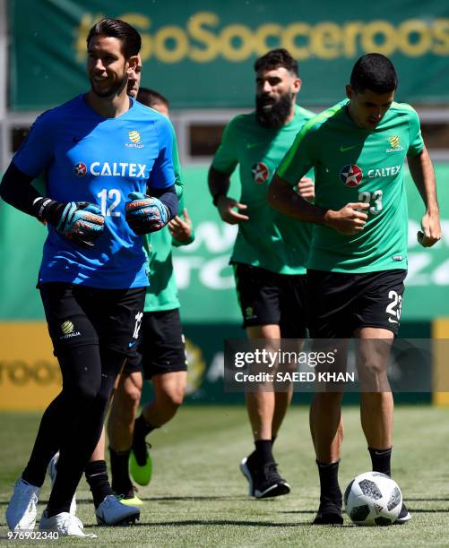 Australia's goalkeeper Brad Jones and midfielder Tomas Rogic warm up for a training session with teammates in Kazan on June 17, 2018 during the...