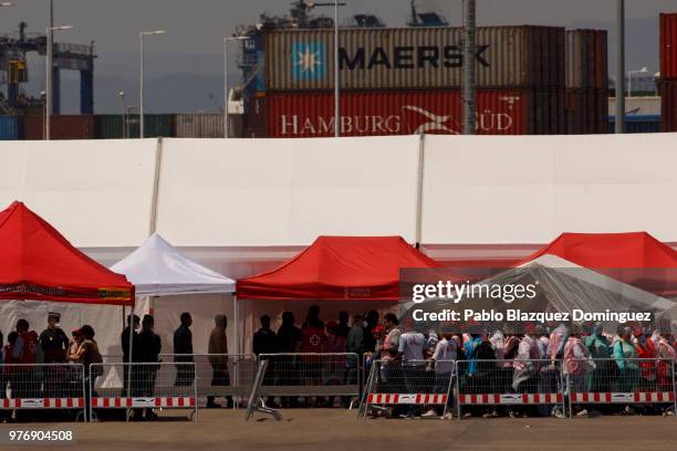 Migrants queue after disembarking from the Aquarius rescue vessel at the Port of Valencia on June 17, 2018 in Valencia, Spain. The Aquarius rescue...