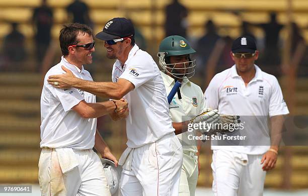England bowler Graeme Swann is congratulated by Kevin Pietersen after the bowler had taken 5 wickets during day three of the 1st Test match between...