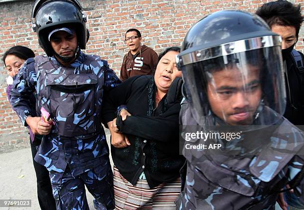 Nepalese riot police arrest Tibetan protesters in front of the consular section of the Chinese Embassy in Kathmandu on March 14 during a protest to...