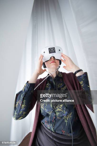 April 2018, Osnabrueck, Germany: An exhibition assistnat wearing the virtual reality glasses for the installation "Rhizomat VR" by the artist Mona el...
