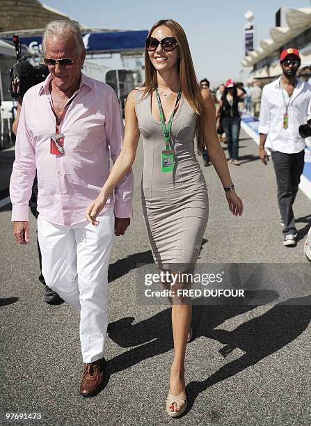 McLaren Mercedes' British driver Jenson Button's father John and girlfriend Jessica Michibata walk on the grid of the Bahrain international circuit...