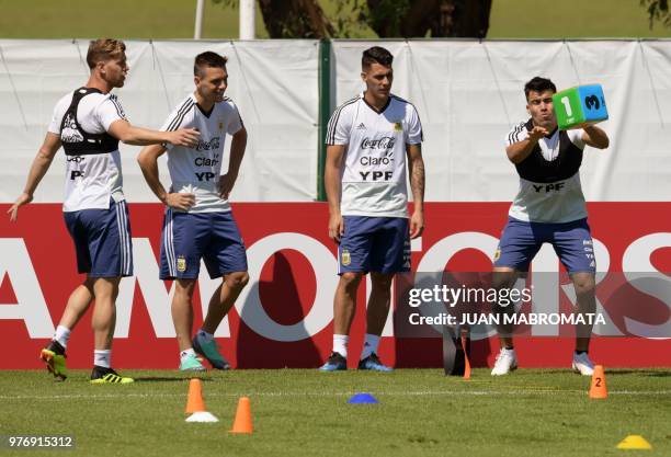 Argentina's defender Marcos Acuna , defender Cristian Ansaldi , midfielder Cristian Pavon and midfielder Giovani Lo Celso attend a training session...