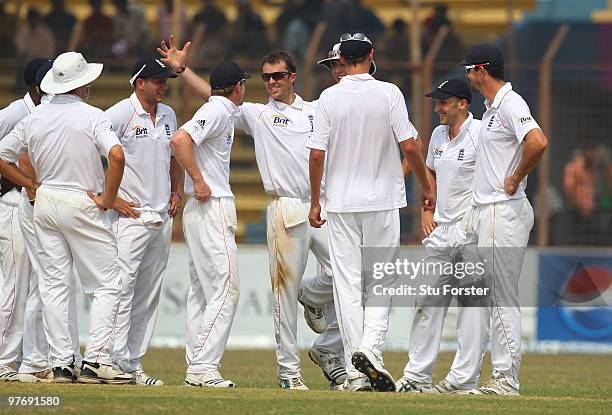 England bowler Graeme Swann shows his team mates how substitute fielder James Tredwell took his catch after he had caught Bangladesh batsman...