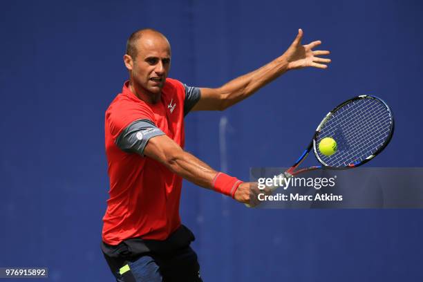 Marius Copil of Romania hits a backhand during his match against John Millman during qualifying Day 2 of the Fever-Tree Championships at Queens Club...