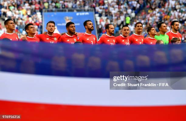 The Costa Rica team are seen from behind their national flag singing their national anthem prior to the 2018 FIFA World Cup Russia group E match...