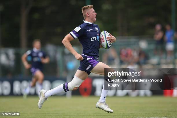 Logan Trotter of Scotland breaks away to score a try during the World Rugby via Getty Images Under 20 Championship 9th Place play-off match between...