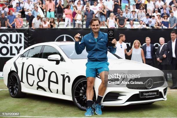 Roger Federer of Switzerland poses with his new Mercedes-Benz CLS 450 4MATIC Coupe after defeating Milos Raonic of Canada in the final match on day 7...