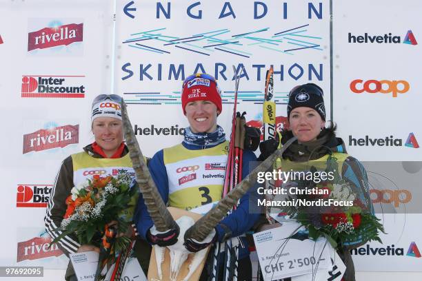 The women's podium with Seraina Mischol of Switzerland taking second place, winner Susanne Nystroem of Sweden and Selina Gasaparin of Switzerland...