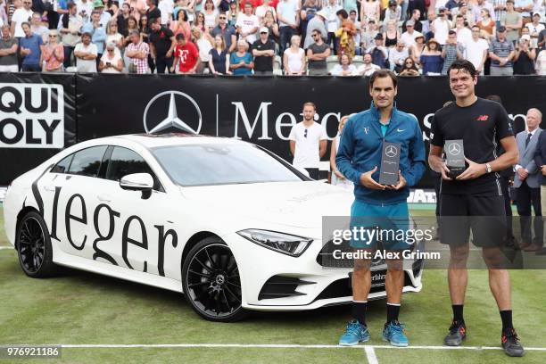 Winner Roger Federer of Switzerland poses with his new Mercedes-Benz CLS 450 4MATIC Coupe and runner up Milos Raonic of Canada after the final match...