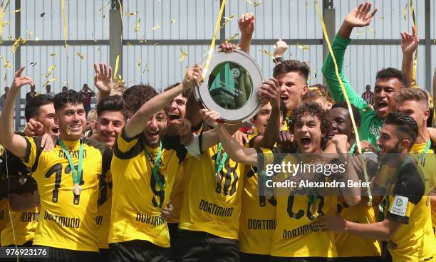 Team captain Alaa Bakir and his teammates of Borussia Dortmund lift the B Juniors German Championship trophy after the final match between FC Bayern...