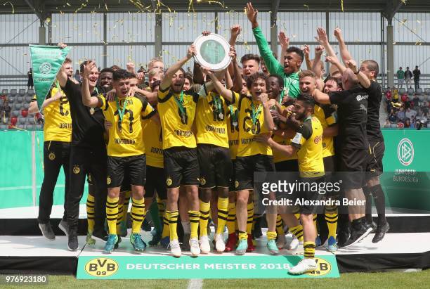 Team captain Alaa Bakir and his teammates of Borussia Dortmund lift the B Juniors German Championship trophy after the final match between FC Bayern...