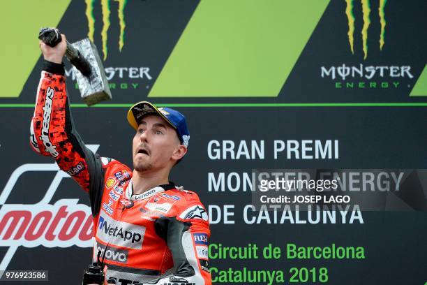 Ducati Team's Spanish rider Jorge Lorenzo celebrates on the podium after winning the Catalunya MotoGP Grand Prix race at the Catalunya racetrack in...