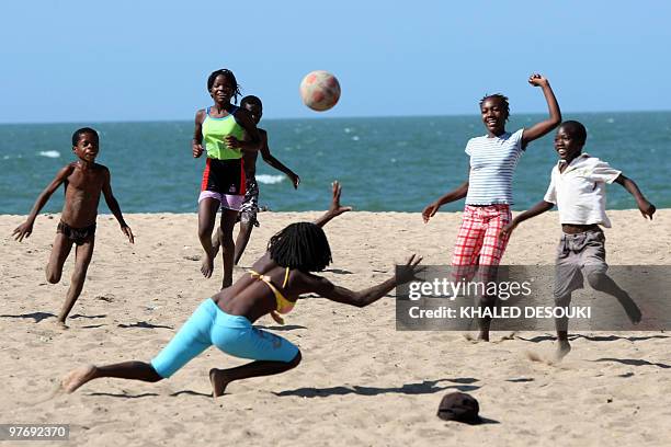 Angolan girls and boys enjoy playing football on the Atlantic ocean beach in Benguela on January 18, 2010 during the African Nations Cup football...