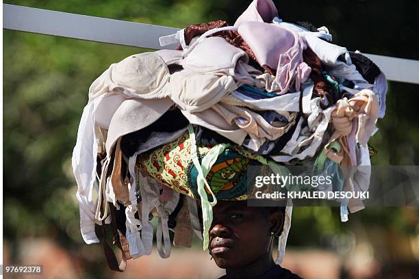 An Angolan woman sells bras in downtown Benguela on January 18, 2010 during the African Nations Cup football tournament which takes place in their...