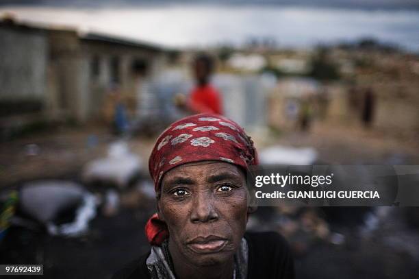 An Angolan woman looks on as she sells charcoals in a popular neighborhood on the road to Tundavala stadium on the eve of the two African Cup of...