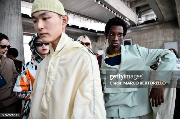 Models pose in the backstage before the show of fashion house Sunnei during the Men's Spring/Summer 2019 fashion shows in Milan, on June 17, 2018.