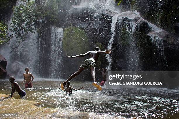 An angolan child dives in the water at the "Cascada de Huila" a natural waterfall on the outskirt of Lubango on January 23, 2010. Lubango will host...