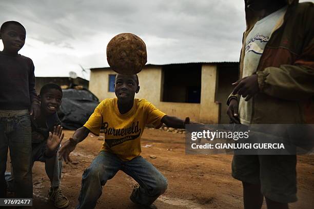 Angolan children play football in the street of Bairo Commercial, a neighbourhood of Lubango, Angola on January 15, 2010. Lubango is one of the four...