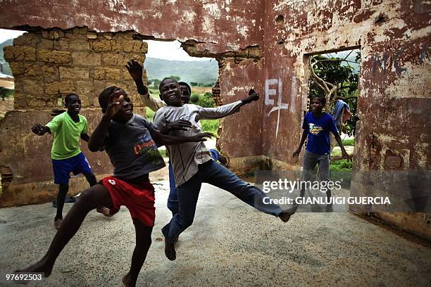 Angolan kids play football inside an abandoned house in a poor neighborhood outside Tundavala Stadium in Lubango, Angola on January 14, 2010. AFP...