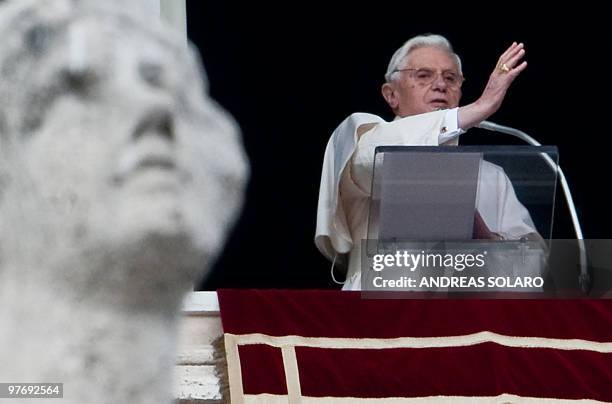 Pope Benedict XVI adrresses faithful from the window of his apartment at the end of his Sunday Angelus prayer in St. Peter's square at the Vatican on...