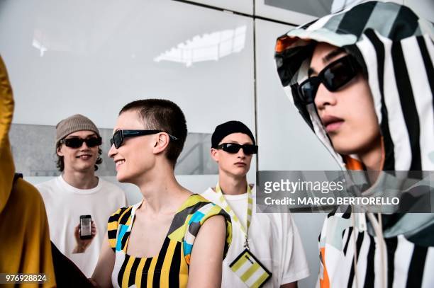 Models pose in the backstage before the show of fashion house Sunnei during the Men's Spring/Summer 2019 fashion shows in Milan, on June 17, 2018.
