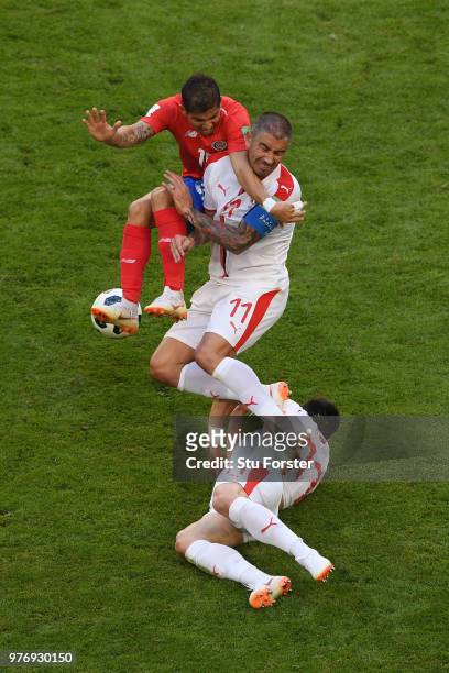 Cristian Gamboa or Costa Rica is challenged by Aleksandar Kolarov and Filip Kostic of Serbia during the 2018 FIFA World Cup Russia group E match...