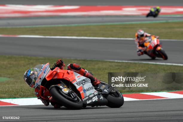 Ducati Team's Spanish rider Jorge Lorenzo, Repsol Honda Team's Spanish rider Marc Marquez and Movistar Yamaha MotoGP's Italian rider Valentino Rossi...