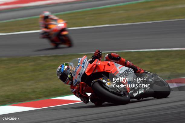 Ducati Team's Spanish rider Jorge Lorenzo and Repsol Honda Team's Spanish rider Marc Marquez ride during the Catalunya MotoGP Grand Prix race at the...