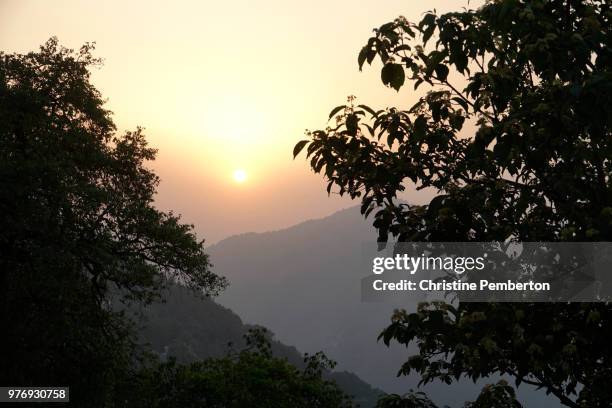 sunset over the mountains in mussoorie, a hill station in northern india. - mussoorie stock pictures, royalty-free photos & images