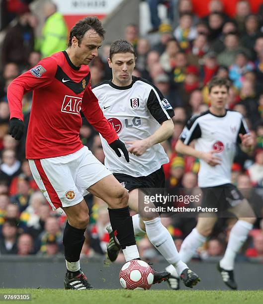 Dimitar Berbatov of Manchester United clashes with Chris Baird of Fulham during the FA Barclays Premier League match between Manchester United and...