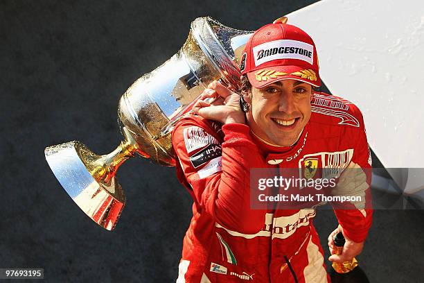 Fernando Alonso of Spain and Ferrari celebrates on the podium after winning the Bahrain Formula One Grand Prix at the Bahrain International Circuit...