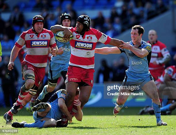 Man of the match Akapusi Qera of Gloucester is tackled by Ben Blair and Gareth Cooper of Cardiff Blues during the LV Anglo Welsh Cup Semi Final match...