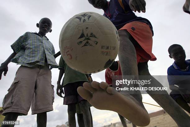 An Angolan boy kicks the ball outside the Stadium of petroleum Academic in Lobito village about 20 km out of Benguela on January 14, 2010 during the...