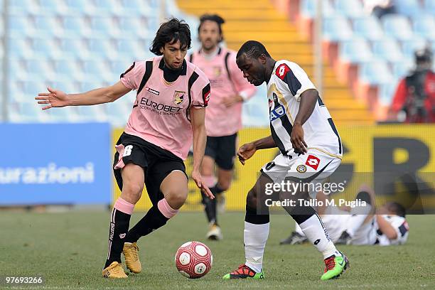 Javier Pastore of Palermo and Asamoah of Udinese compete for the ball during the Serie A match between Udinese Calcio and US Citta di Palermo at...
