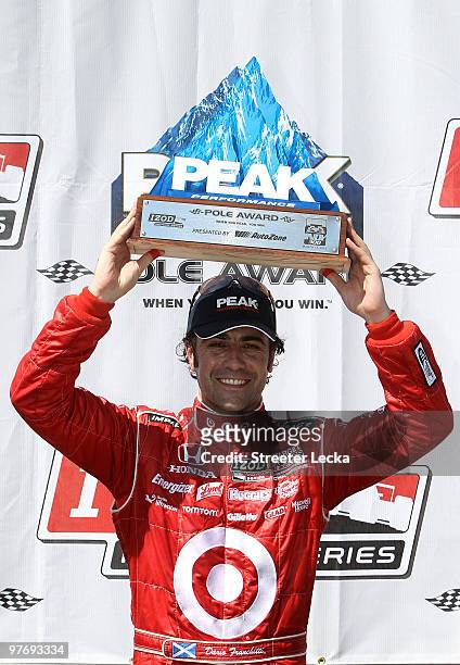 Dario Franchitti of Great Britain, driver of the Target Chip Ganassi Dallara Honda, celebrates after winning the pole position during qualifying for...