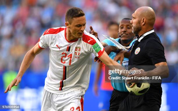 Nemanja Matic of Serbia tries to get the ball from a Costa Rica official as fourth official tries to step in during the 2018 FIFA World Cup Russia...