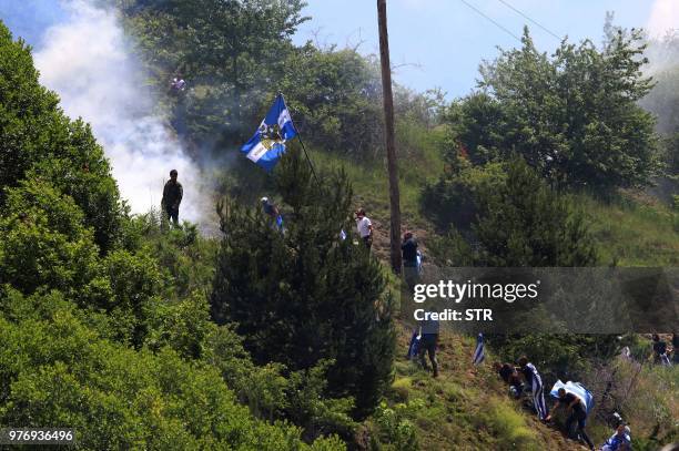 Protestors clashes with riot police during a protest at the village of Pisoderi near the border with Macedonia in northern Greece on July 17, 2018 as...