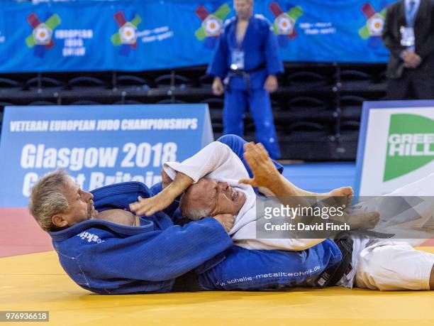 Wolfgang Loeffler of Germany strangles Heinz Brauer of Switzerland into submission to reach the u73kg M8 final and the gold medal during day 1 of the...
