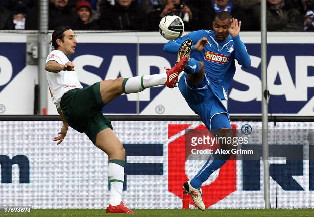 Claudio Pizarro of Bremen is challenged by Marvin Compper of Hoffenheim during the Bundesliga match between 1899 Hoffenheim and Werder Bremen at the...