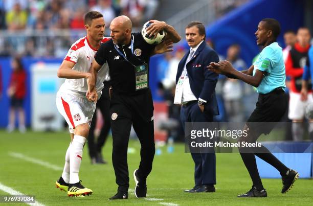 Nemanja Matic of Serbia tries to get the ball from Costa Rica coach Luis Marin as fourth official tries to step in during the 2018 FIFA World Cup...