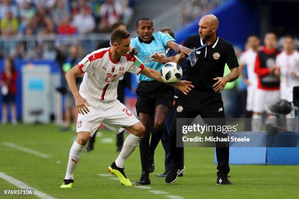 Nemanja Matic of Serbia tries to get the ball from Costa Rica coach Luis Marin as fourth official tries to step in during the 2018 FIFA World Cup...